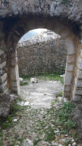 an archway in a stone wall with a view at Castle Hotel in Himare