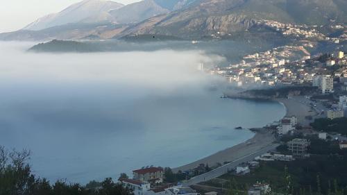 a view of a city and a body of water at Castle Hotel in Himare