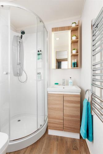 a bathroom with a shower and a sink and a toilet at Visby Strandby in Visby