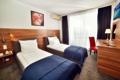 Postel nebo postele na pokoji v ubytování Hotel President