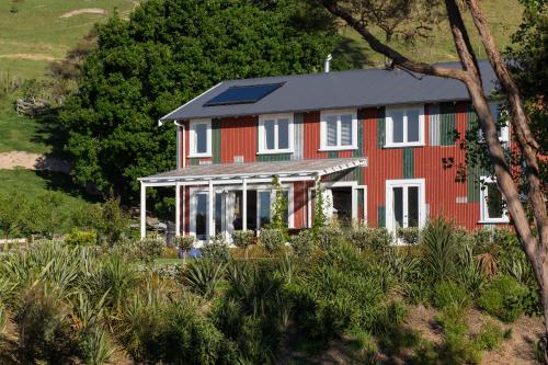 a red house with a solar roof on a hill at The Pear Orchard Lodge in Richmond