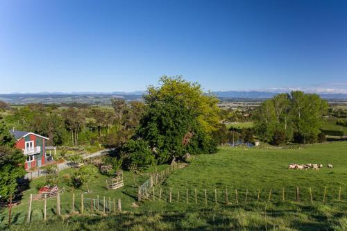 an aerial view of a farm with cows in a field at The Pear Orchard Lodge in Richmond