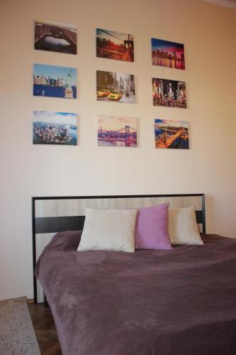 a bed in a bedroom with pictures on the wall at New York Hostel in Lviv