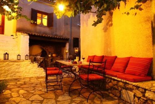 a patio with a couch and chairs and a table at Villa Polyxeni in Sivota