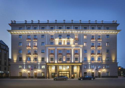 
a large building with a large clock on the front of it at Grand Hotel Kempinski Riga in Riga
