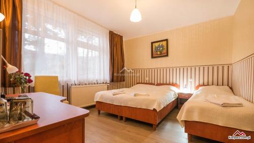 Habitación de hotel con 2 camas y ventana en Ustronie, en Karpacz