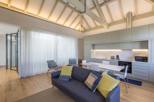 a living room with a blue couch and a table at Casa Amarela in Porto