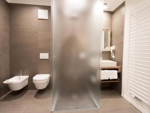 a bathroom with a toilet and a sink at Apartments Sissi & Franz in Merano
