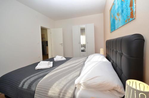 a bedroom with a bed with two towels on it at Stella Apartments in Novigrad Istria