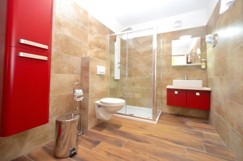 a bathroom with a toilet and a shower and a sink at Stella Apartments in Novigrad Istria