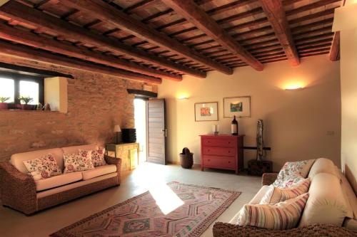 a living room with two couches and a red dresser at Agriturismo Segnavento in Staffolo
