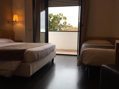 Postel nebo postele na pokoji v ubytování Hotel Sisto V