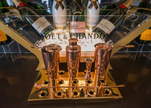a wine rack with wine bottles and wine glasses at Hythe Imperial Hotel, Spa & Golf in Hythe