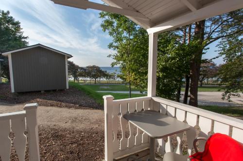a porch with a bench and a shed at Visby Strandby in Visby