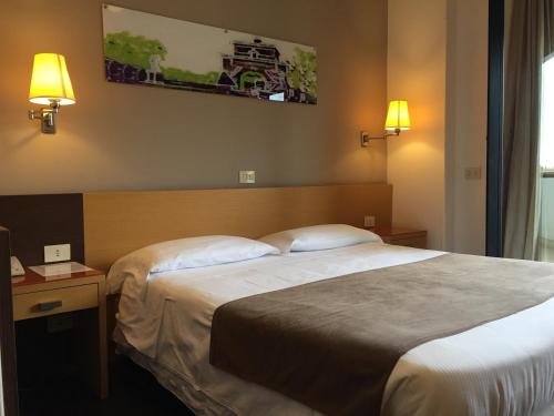 Postel nebo postele na pokoji v ubytování Hotel Sisto V