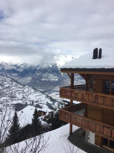 a log cabin with snow on the roof at Le Preyet in Veysonnaz