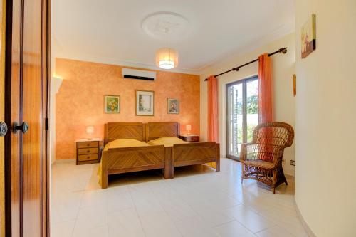 a bedroom with a bed and a table and a window at Villas2go2 V5 Vilamoura XXI in Vilamoura