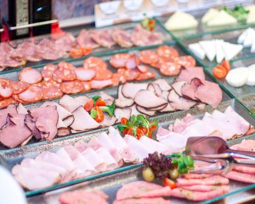a display of different types of meats and cheese at Hello Hotels Bucuresti Gara de Nord in Bucharest