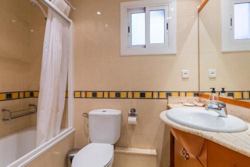a bathroom with a toilet and a sink and a shower at ApartEasy - Port Barcelona in Barcelona