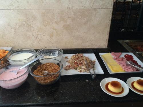 a counter with a bunch of food on a table at Hotel Marlowe Centro Histórico in Mexico City