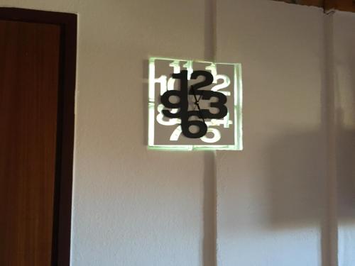 a sign on a wall with the number on it at Fehérló Vendégház & Restaurant in Bük