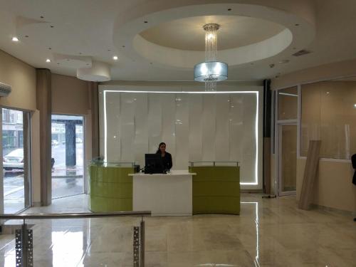 a person sitting at a desk in a lobby at Solrand Hotel in Durban
