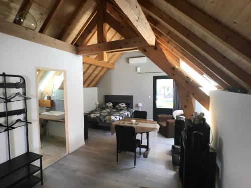 a living room with a bed and a table at Golf de La Chassagne in Mâlain