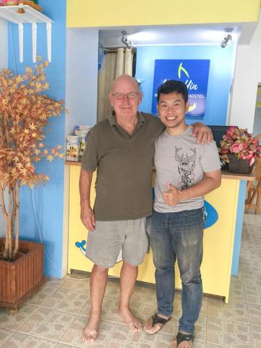 an older man standing next to a young boy at HuaHin Night Market Hostel in Hua Hin
