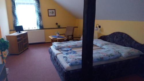 a bedroom with two beds and a dresser and a window at Penzion u modrého zvonku in Zlaté Hory