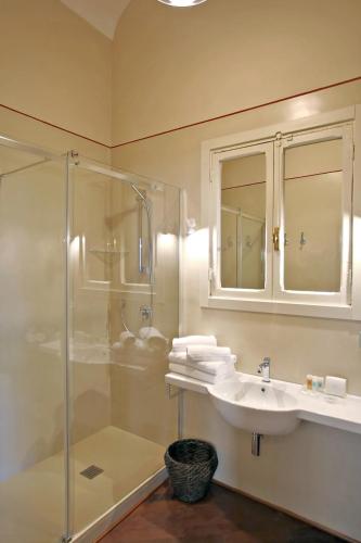 a bathroom with a sink and a glass shower at Hotel Scalinata Di Spagna in Rome