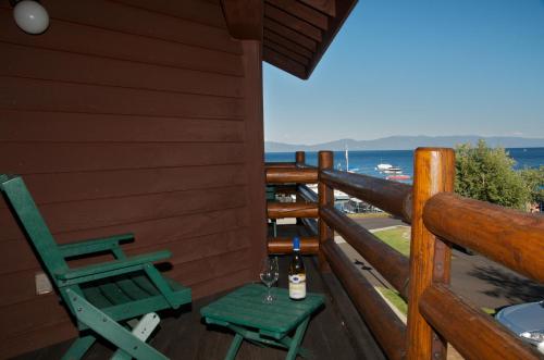 a porch with two chairs and a bottle of wine at Sunnyside Resort and Lodge in Tahoe City