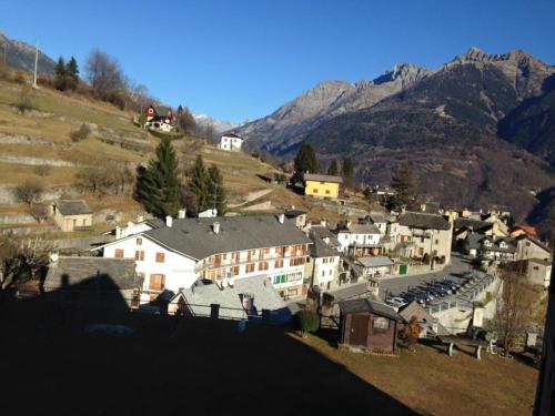 a group of buildings in a town with a mountain at B&B Il Paradiso Mozzio in Mozzio