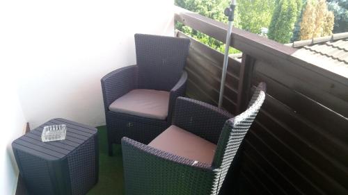 a balcony with two chairs and a table at Fehérló Vendégház & Restaurant in Bük