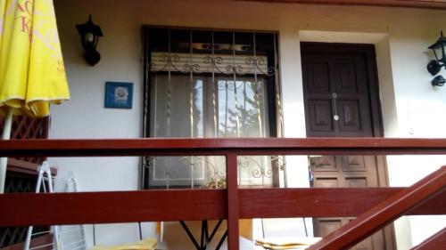 a house with a balcony with a door at Fehérló Vendégház & Restaurant in Bük