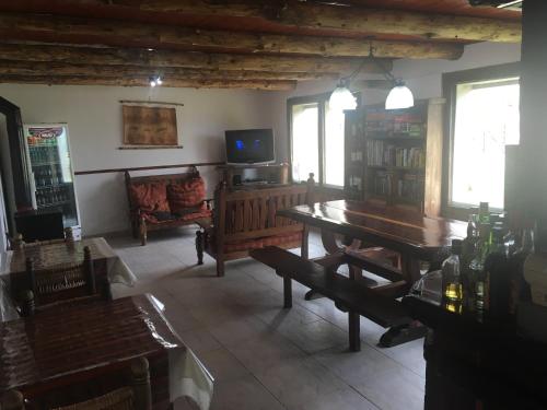 a living room with a table and a tv at Albergue Aylen-Aike in El Chalten