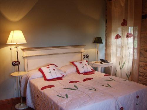 a bedroom with a bed with two pillows on it at Casa Almoina in Viveiro