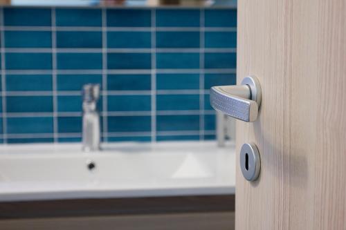 a bathroom door with a sink and a faucet at Il Merlo Verde in Monteverdi Marittimo