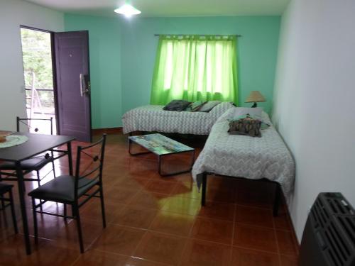 a room with a bed and a table and a dining room at DEPARTAMENTOS YAPAY PEÑI in Plottier