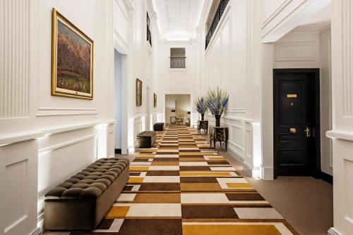 a hallway with a checkered floor in a building at Alvear Palace Hotel - Leading Hotels of the World in Buenos Aires