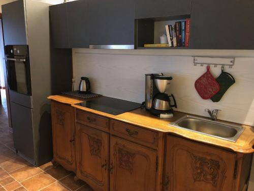 a kitchen with a sink and a counter top at Apartament Perła Kartuz z sauną in Kartuzy