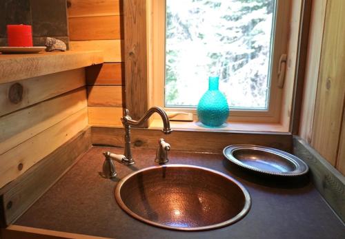 a sink in a tiny house with a window at Logden Lodge in Nelson
