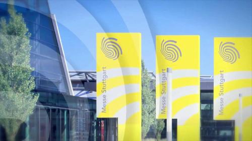 a row of yellow banners in front of a building at Apartments Drei Morgen in Leinfelden-Echterdingen