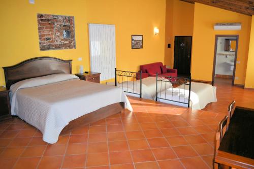 a bedroom with a bed and a living room at Corte Certosina in Trezzano sul Naviglio