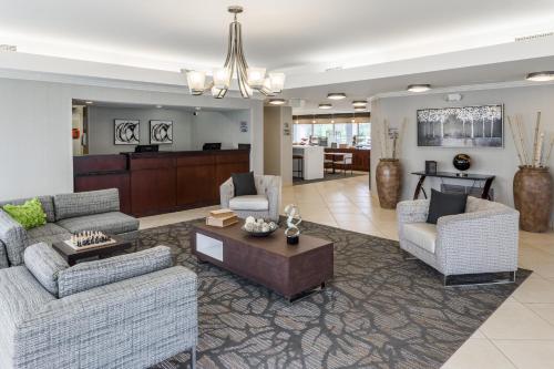 a large living room with two couches and a table at Wingate by Wyndham Shreveport Airport in Shreveport