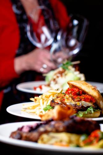 a woman sitting at a table with plates of food at Mirabeau Park Hotel in Spokane Valley