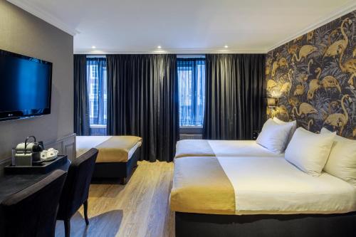 Letto o letti in una camera di Hotel Sint Nicolaas