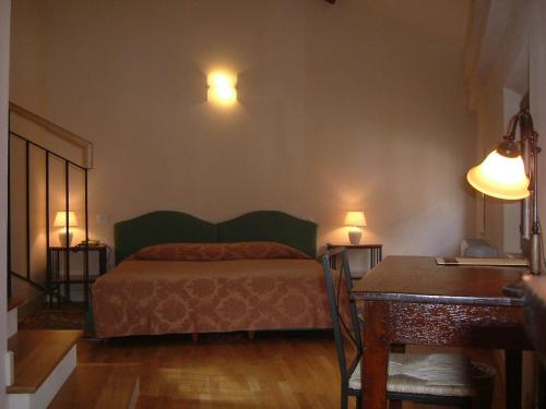 a bedroom with a bed and two lights on the wall at Hotel De Prati in Ferrara