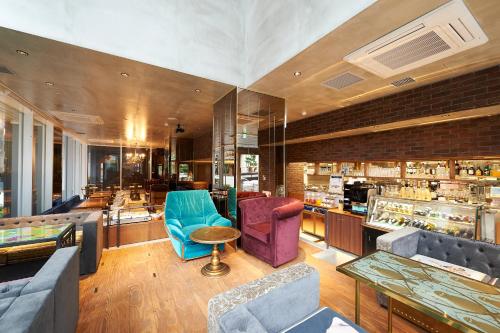 a lobby with blue and purple chairs and a bar at Sotetsu Fresa Inn Tokyo Roppongi in Tokyo