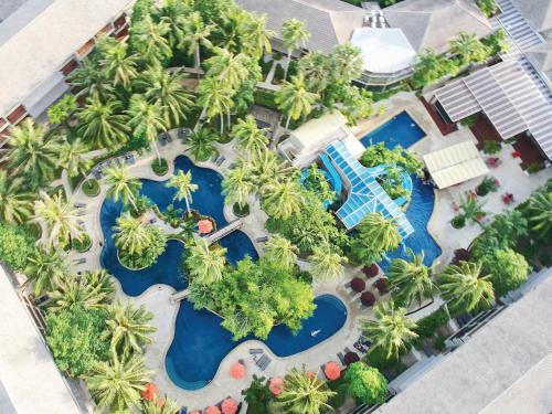 an aerial view of a resort with palm trees and a pool at Holiday Inn Resort Phuket Surin Beach, an IHG Hotel in Surin Beach