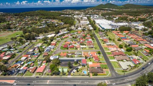 an aerial view of a city with houses and a road at Hotel Forster in Forster